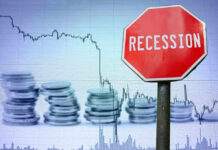 Recession sign, coin stacks, downward stock chart background.