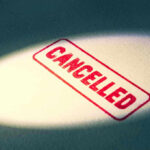 Red Cancelled stamp under a spotlight.