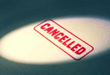 Red Cancelled stamp under a spotlight.