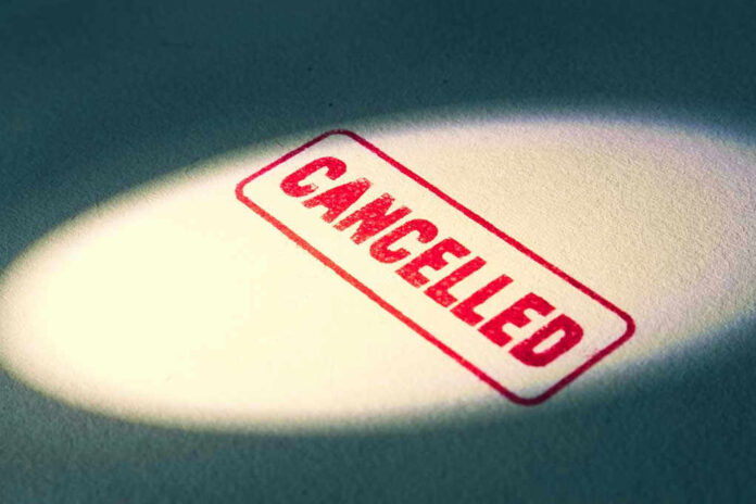 Red Cancelled stamp under a spotlight.