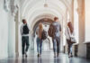 Four students walking in a corridor together.