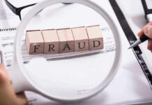 Fraud blocks under magnifying glass on invoices.