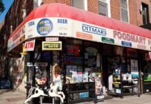 Exterior view of a convenience store with various signs and advertisements