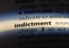 Close-up of a dictionary page showing the definition of 'indictment'