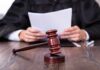 Judge’s Shocking Leniency: Domestic Violence Uproar A judge holding documents with a gavel in the foreground