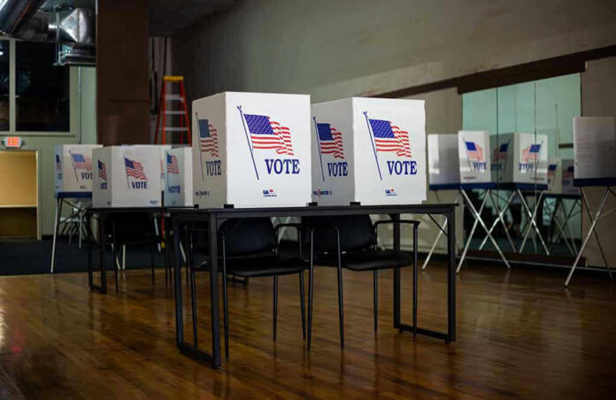 1837302946 Voting booths set up in a room.