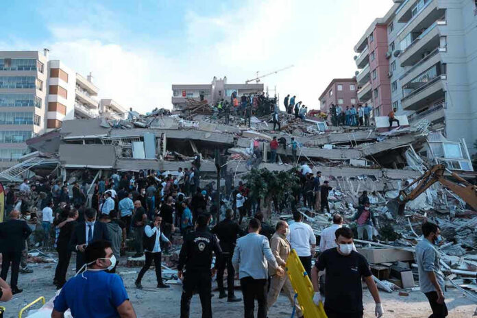 1845063010 People at a collapsed building after an earthquake.