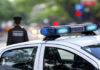 Police car and officer on a city street.