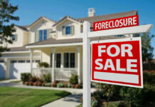 House for sale with foreclosure sign.