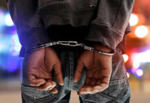 Texas Man ARRESTED – Threats to INFLUENCER Exposed Person in handcuffs with colorful lights in background.