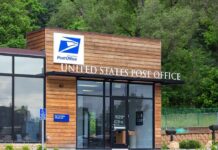 Exterior view of a modern United States Post Office building surrounded by greenery