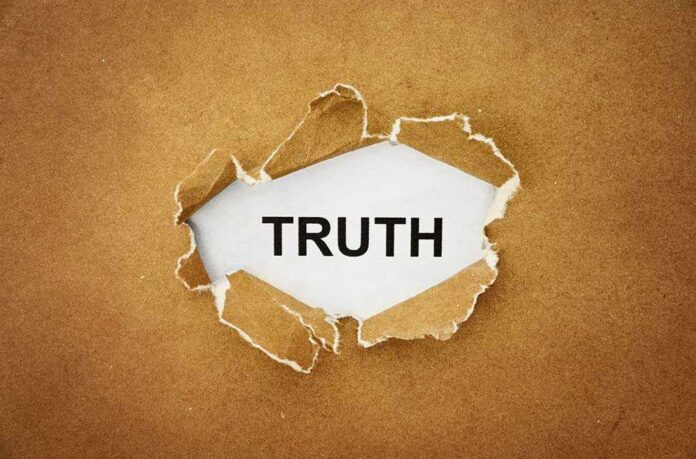 shutterstock_211611715.jpg A piece of torn paper revealing the word TRUTH underneath