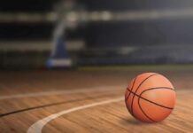 LEGENDARY Icon Admits Years-Long Basketball Secret A basketball resting on a wooden court