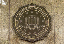 FBI seal on a marble wall.