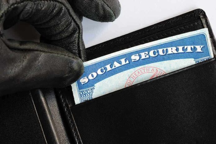 A gloved hand retrieving a social security card from a wallet
