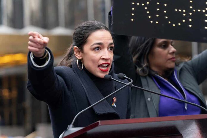 shutterstock_1289128096 (6).jpg A woman passionately speaking at a rally with a sign in the background
