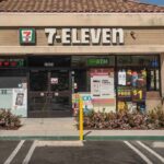 Exterior view of a 7-Eleven convenience store with an ATM
