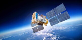 A satellite equipped with solar panels orbiting above the Earth