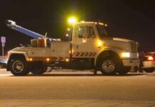 City Fails Hard—Dead Man Rides for 15 Days Tow truck with flashing lights parked at night