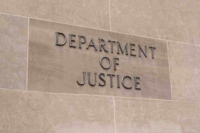 Sign displaying 'Department of Justice' on a stone wall