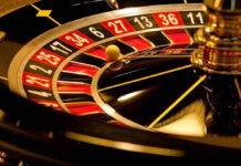 Close-up of roulette wheel with spinning ball.