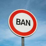Sign with word BAN against clear sky.