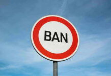 Sign with word BAN against clear sky.