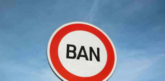 Sign with word BAN against clear sky.
