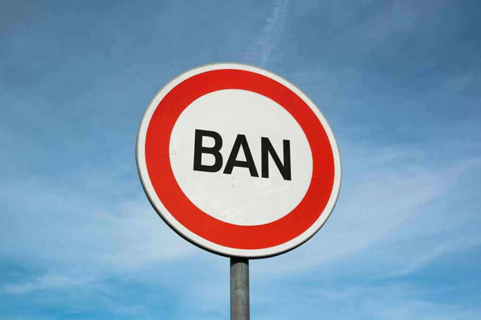 Sign with word BAN against clear sky.