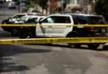 Molotov Attack ROCKS Federal Building Police tape blocking street with patrol cars.