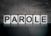 Blocks spelling PAROLE on grungy background.