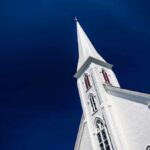 White church steeple against a clear blue sky