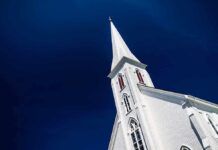 White church steeple against a clear blue sky
