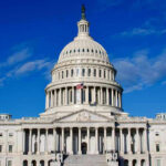 US Capitol Building against blue sky.