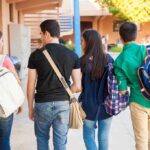 Group of students walking together in a school corridor