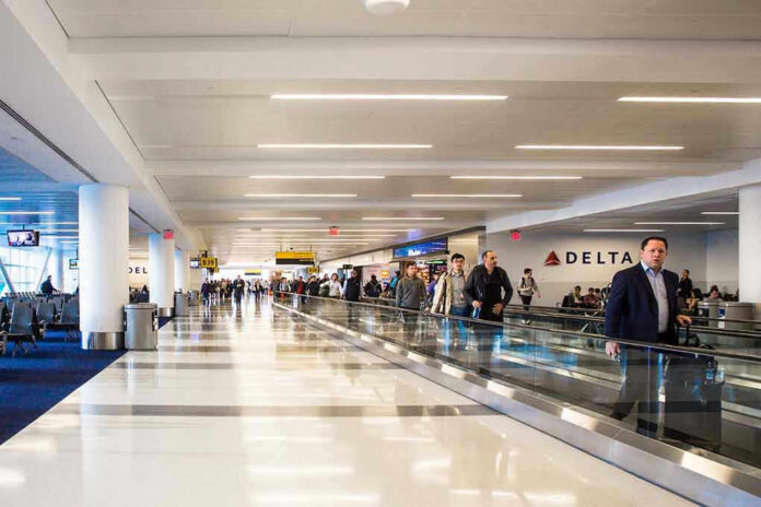 People walking through an airport terminal.