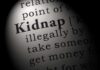 Close-up of a dictionary page showing the definition of the word 'kidnap'
