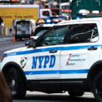 Iranian Flag Attacker HUNTING Jews NYPD police car on a city street scene.