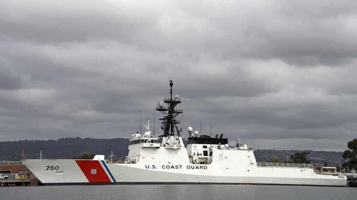 A U.S. Coast Guard ship docked under cloudy skies