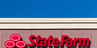 State Farm logo displayed on a building against a blue sky
