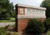Sign for Michigan State University surrounded by greenery