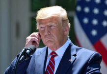 Trump’s Outsider STUNS GOP After Upending RINO! Man in a suit adjusting an earpiece.