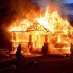 CA Wildfires SPARK CHAOS – Urgent Evacuations! House engulfed in flames with firefighters present.