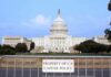 View of the U.S. Capitol building with a security barrier in front