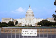 Omar EXPULSION Battle: House Prepares Motion View of the U.S. Capitol building with a security barrier in front