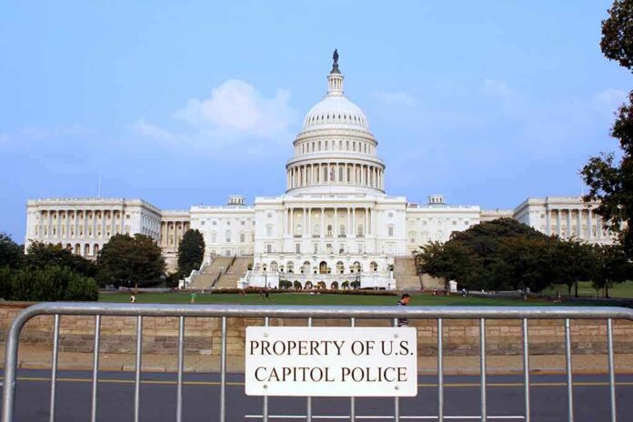 shutterstock_1913280 View of the U.S. Capitol building with a security barrier in front