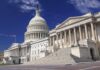 The U.S. Capitol building with its dome and columns under a blue sky