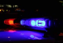 Shock Arrest Crushes Brewing Empire Close-up of police lights flashing in blue and red at night
