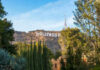 Hollywood Star MURDERED – Girlfriends Kid ARRESTED! Hollywood sign on hill surrounded by trees and buildings.