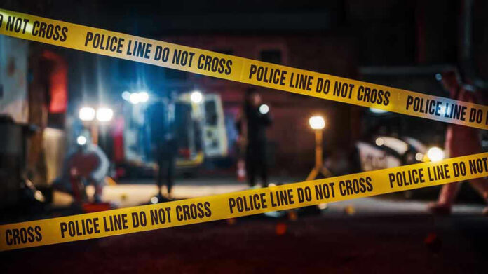 2230645955 Yellow police tape in front of crime scene.
